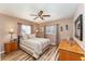 Bright bedroom with wood-look floors and ceiling fan at 9910 Se 138Th Loop, Summerfield, FL 34491