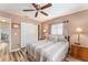 Bedroom with wood-look floors and ceiling fan at 9910 Se 138Th Loop, Summerfield, FL 34491