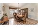 Elegant dining room with hardwood floors, a large table, and a beautiful chandelier at 9910 Se 138Th Loop, Summerfield, FL 34491