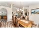 Bright dining area with hardwood floors, a formal dining set and kitchen views at 9910 Se 138Th Loop, Summerfield, FL 34491