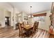 Formal dining room featuring hardwood floors, a wood dining table, and a chandelier at 9910 Se 138Th Loop, Summerfield, FL 34491