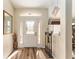 Light-filled entryway with hardwood floors and decorative accents at 9910 Se 138Th Loop, Summerfield, FL 34491