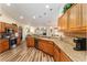 Modern kitchen with stainless steel appliances, granite countertops, and an island at 9910 Se 138Th Loop, Summerfield, FL 34491