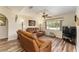 Living room with two leather recliners, wood floors, and a large window at 9910 Se 138Th Loop, Summerfield, FL 34491