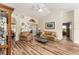 Living room showcases hardwood floors, comfortable furnishings and access to other rooms at 9910 Se 138Th Loop, Summerfield, FL 34491