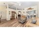 Bright living room with hardwood floors, comfortable seating, and views into adjacent rooms at 9910 Se 138Th Loop, Summerfield, FL 34491