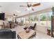 Relaxing sunroom featuring comfortable furniture and natural light at 9910 Se 138Th Loop, Summerfield, FL 34491