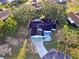 Aerial view of single-story home with driveway and mature trees at 10185 Se 175Th Ln, Summerfield, FL 34491