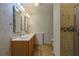 Bathroom with a double sink vanity and tiled walk-in shower at 10185 Se 175Th Ln, Summerfield, FL 34491