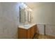 Bathroom with a double sink vanity, large mirrors, and neutral paint at 10185 Se 175Th Ln, Summerfield, FL 34491