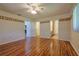 Bright bedroom with laminate flooring and ceiling fan leading to the walk-in closet and ensuite bathroom at 10185 Se 175Th Ln, Summerfield, FL 34491