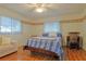 Bright bedroom with hardwood floors and ceiling fan at 10185 Se 175Th Ln, Summerfield, FL 34491