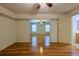Secondary bedroom with laminate floors leading to the combined sitting area and en-suite bathroom at 10185 Se 175Th Ln, Summerfield, FL 34491