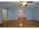 Large bedroom featuring laminate flooring and ceiling fan leading to a secondary room through double doors at 10185 Se 175Th Ln, Summerfield, FL 34491