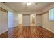 Spacious bedroom with wood laminate flooring and decorative wall border leading to the bathroom and closet at 10185 Se 175Th Ln, Summerfield, FL 34491