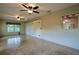 A bright bonus room features a window, ceiling fans, and sliding barn doors for flexible living at 10185 Se 175Th Ln, Summerfield, FL 34491
