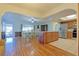 Open concept dining area with hardwood floors and kitchen island at 10185 Se 175Th Ln, Summerfield, FL 34491