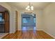Light-filled dining area with beautiful hardwood floors and decorative chandelier at 10185 Se 175Th Ln, Summerfield, FL 34491