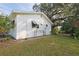 Side view showcasing home's white siding and landscaping at 10185 Se 175Th Ln, Summerfield, FL 34491