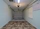 View of an attached garage with automatic door, overhead lighting, and overhead storage rack at 10185 Se 175Th Ln, Summerfield, FL 34491