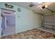 Attached garage featuring textured tile flooring, water heater, and access door to interior of the home at 10185 Se 175Th Ln, Summerfield, FL 34491