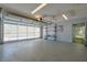 Clean, well-lit garage space featuring large glass panel garage door at 10185 Se 175Th Ln, Summerfield, FL 34491