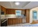 Cozy kitchen with wood cabinets, granite countertops and stainless steel appliances at 10185 Se 175Th Ln, Summerfield, FL 34491