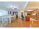 Open kitchen and dining area with hardwood floors and stainless steel appliances at 10185 Se 175Th Ln, Summerfield, FL 34491