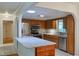 Well-appointed kitchen with stainless steel appliances, granite countertops, and wood cabinetry at 10185 Se 175Th Ln, Summerfield, FL 34491