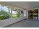 Screened lanai providing a view of a well-maintained backyard with mature trees at 10185 Se 175Th Ln, Summerfield, FL 34491