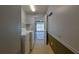 Functional laundry area with washer, dryer, shelving, and a view of the garage at 10185 Se 175Th Ln, Summerfield, FL 34491