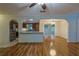 Open concept view of the kitchen and dining room featuring stainless steel appliances and hardwood floors at 10185 Se 175Th Ln, Summerfield, FL 34491