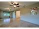Spacious living room with tile floors, ceiling fans, and a view of the dining area at 10185 Se 175Th Ln, Summerfield, FL 34491