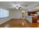 Open-concept living room boasts wood floors and a seamless flow into the adjacent kitchen at 10185 Se 175Th Ln, Summerfield, FL 34491