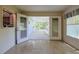 Bright sunroom leading to a screened lanai with outdoor access at 10185 Se 175Th Ln, Summerfield, FL 34491