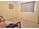 Simple bedroom with carpeted floor and window at 10736 Sw 62Nd Ave, Ocala, FL 34476