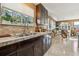 Bright kitchen features double sink, tile counters, and dark wood cabinets at 10962 Sw 80 Ct, Ocala, FL 34481