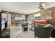 Open living and dining area with light wood floors and a comfy orange couch at 10962 Sw 80 Ct, Ocala, FL 34481