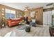 Bright living room with leather sofa, wood flooring, and decorative wall art at 10962 Sw 80 Ct, Ocala, FL 34481