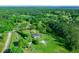 Aerial view of a house with lush green surroundings at 11540 Se Highway 464, Ocklawaha, FL 32179