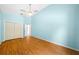 Bedroom with light blue walls and wood floors at 11540 Se Highway 464, Ocklawaha, FL 32179