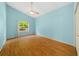 Light blue bedroom with wood floors and ceiling fan at 11540 Se Highway 464, Ocklawaha, FL 32179