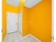 Bright yellow hallway with tile flooring and two doors at 11540 Se Highway 464, Ocklawaha, FL 32179