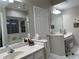 Bathroom with double vanity and a view of the tub at 11557 Sw 75Th Cir, Ocala, FL 34476