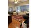 Sunlit living room with bay window, comfy seating and hardwood floors at 11557 Sw 75Th Cir, Ocala, FL 34476