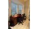 Home office with built-in desk and large windows with blinds at 11557 Sw 75Th Cir, Ocala, FL 34476