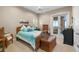 Cozy bedroom with wicker furniture and access to outdoor patio at 13041 Se 158Th Ln, Weirsdale, FL 32195