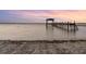 Wooden pier extending over calm lake waters at sunset at 13041 Se 158Th Ln, Weirsdale, FL 32195