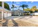 Home's exterior showcases a two-car garage and palm trees at 13041 Se 158Th Ln, Weirsdale, FL 32195