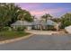 House exterior at dusk with a metal roof and a long driveway at 13041 Se 158Th Ln, Weirsdale, FL 32195